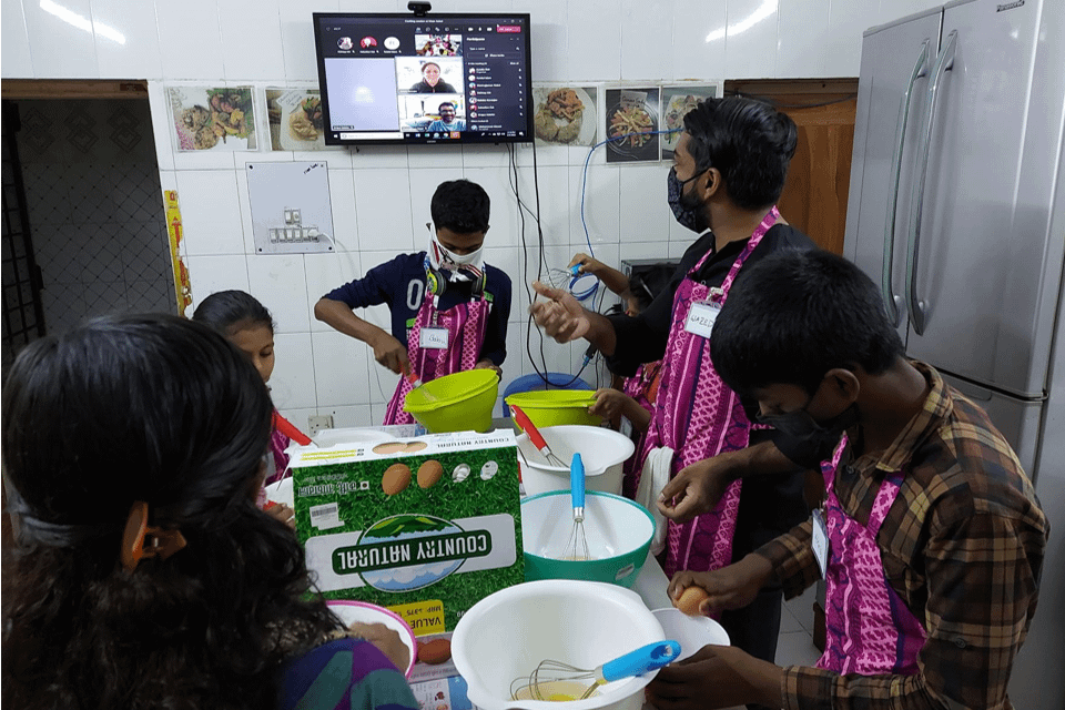 OI Employees cooking virtually with Maer Achol kids